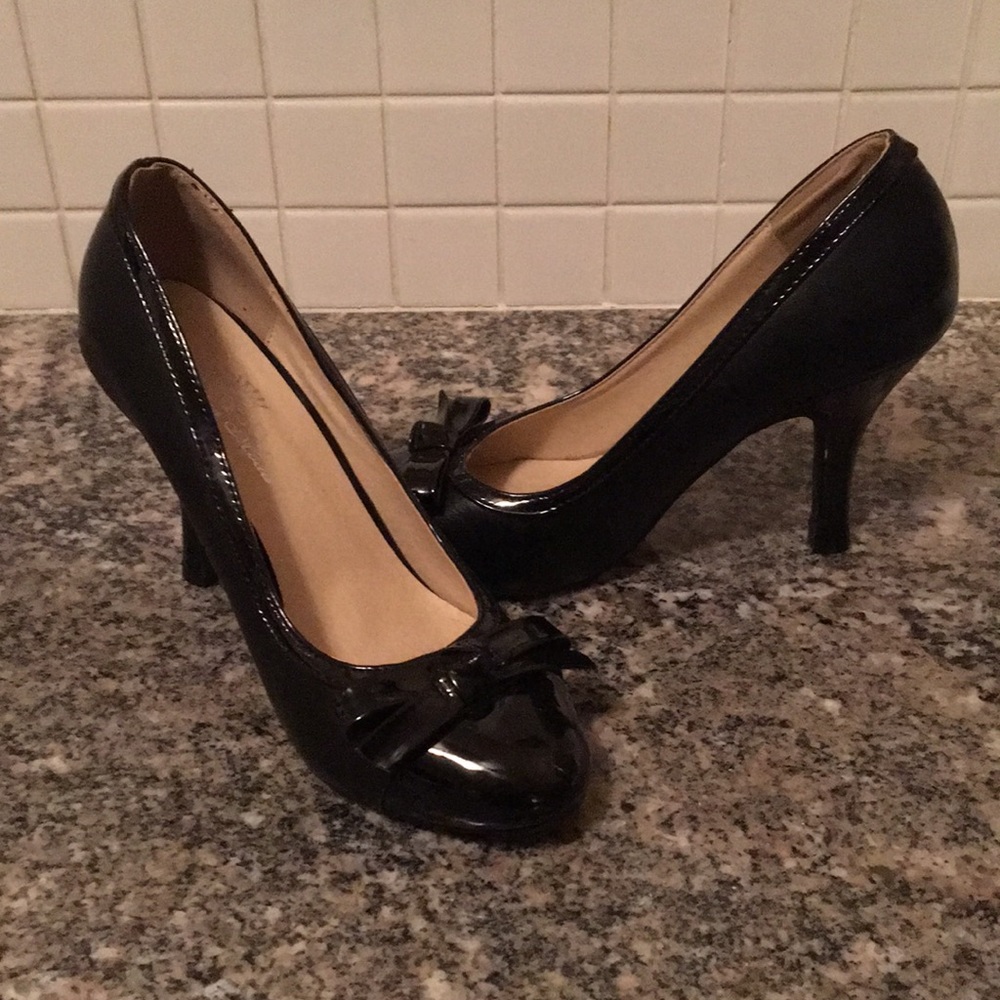 Black 2 inch heels with bows on the toes